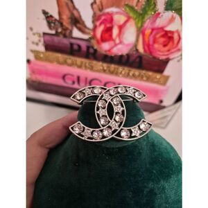 Authentic Chanel, silver tone breach with studs and stars